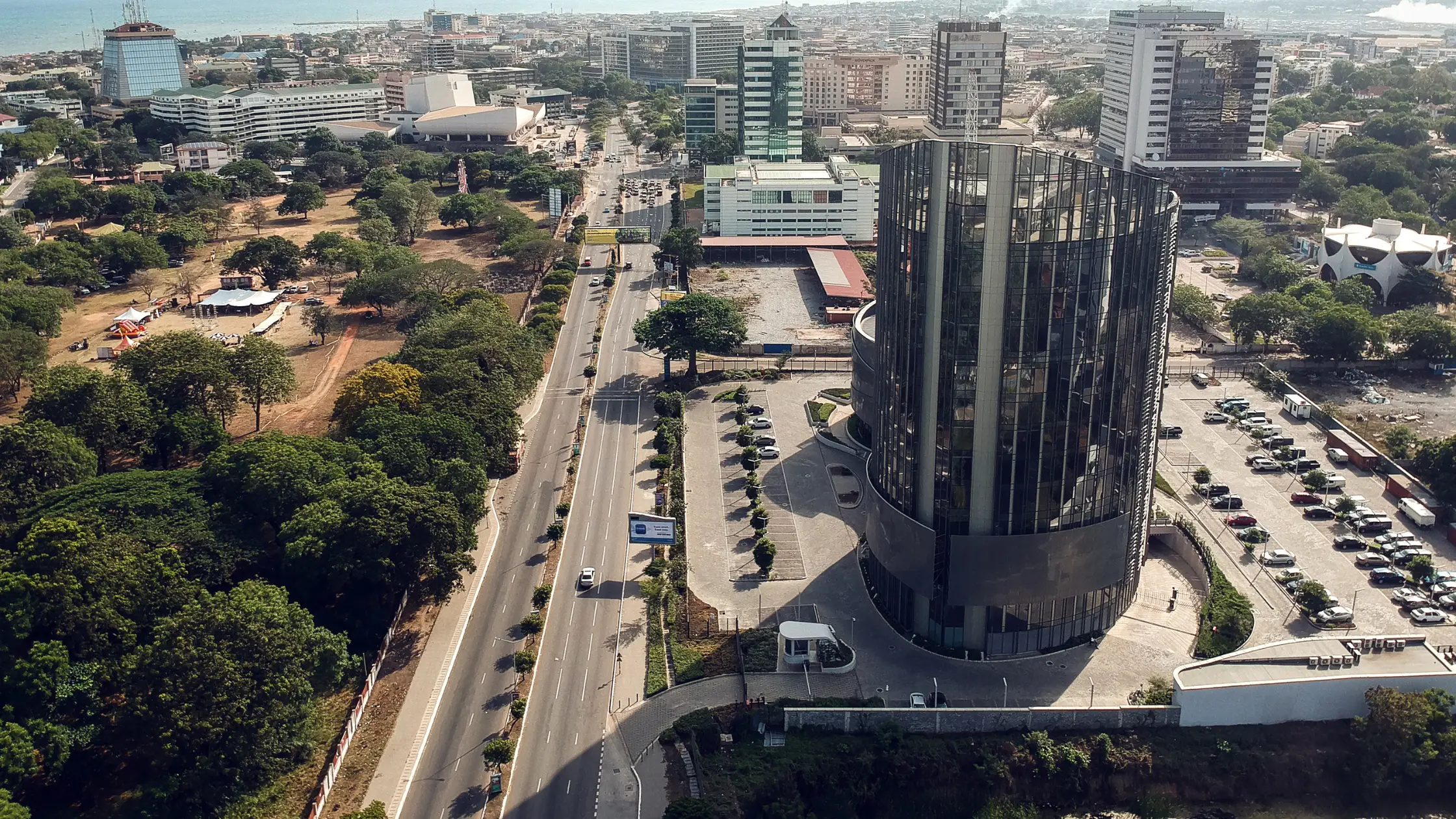 Aerial view of modern skyscrapers and corporate buildings in the Accra financial district, showcasing the economic infrastructure for entrepreneurs starting a business in Ghana.